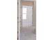 Bright hallway with neutral walls and carpet, showing view through doorway at 222 Gilead Rd, Huntersville, NC 28078