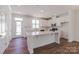 Bright kitchen with white cabinets, an island, stainless steel appliances, and a modern design at 222 Gilead Rd, Huntersville, NC 28078