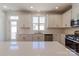 Bright kitchen with an island, stainless steel appliances, and white cabinets with hardware at 222 Gilead Rd, Huntersville, NC 28078