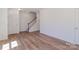Clean and bright living room with wood-look floors and staircase, offering a welcoming atmosphere at 222 Gilead Rd, Huntersville, NC 28078