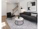Staged living room featuring contemporary furniture, a patterned rug, and wood-look floors at 222 Gilead Rd, Huntersville, NC 28078