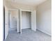 Bedroom with grey carpet and walk-in closet at 2707 Crescent Ln, Gastonia, NC 28052