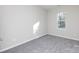 Spacious bedroom with grey carpet and a window at 2707 Crescent Ln, Gastonia, NC 28052