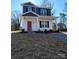 Two-story house with gray and white siding, red door, and small porch at 2707 Crescent Ln, Gastonia, NC 28052
