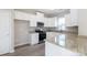Modern kitchen with white cabinets, granite countertops, and stainless steel appliances at 2707 Crescent Ln, Gastonia, NC 28052