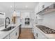 Modern kitchen with white cabinets, stainless steel appliances, and white quartz countertops at 1190 Lost Cove Rd, Indian Land, SC 29707