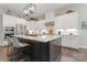 Modern kitchen with stainless appliances, white subway tile backsplash, ample white cabinetry, and a dark island at 4028 Brandywine Ter, Lancaster, SC 29720