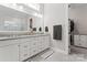 Elegant main bathroom with double sink vanity, large mirror, and walk-in closet access at 4028 Brandywine Ter, Lancaster, SC 29720