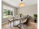 Modern dining room featuring a concrete table and stylish light fixture at 2178 Eastview Rd, Rock Hill, SC 29732