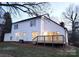 Rear elevation of a home with a new deck and nice yard at 513 Mary Charlotte Dr, Charlotte, NC 28262