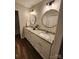 Bathroom with double granite vanity, framed round mirrors and wood-look floors at 513 Mary Charlotte Dr, Charlotte, NC 28262