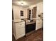 Modern kitchen featuring stainless steel oven, granite countertops, white cabinets, and wood-look flooring at 513 Mary Charlotte Dr, Charlotte, NC 28262