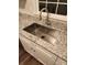 Close-up of a stainless steel kitchen sink with granite countertops and white cabinets at 513 Mary Charlotte Dr, Charlotte, NC 28262