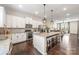 Modern kitchen with white cabinets, granite countertops, island, and open layout at 9714 Ainslie Downs St, Charlotte, NC 28273