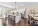 Modern kitchen with white cabinets, granite countertops, and island with seating at 9714 Ainslie Downs St, Charlotte, NC 28273