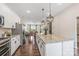 Modern kitchen with white cabinets, granite countertops, and an island at 9714 Ainslie Downs St, Charlotte, NC 28273