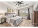 Spacious main bedroom with carpeted floors, large bed, and neutral decor at 9714 Ainslie Downs St, Charlotte, NC 28273