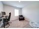 Bright bedroom with window, carpeted floor, and workspace at 102 Guardian Gate Dr, Mooresville, NC 28115