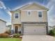 Two-story house with beige siding, stone accents, and a two-car garage at 102 Guardian Gate Dr, Mooresville, NC 28115