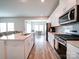 Modern kitchen with white cabinets, stainless steel appliances, and an island at 102 Guardian Gate Dr, Mooresville, NC 28115