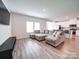 Living room with sectional sofa and wood-look floors at 102 Guardian Gate Dr, Mooresville, NC 28115