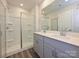 Bathroom with a dual sink vanity, frameless shower glass, and modern gray cabinetry at 1636 Village Grove Ln, Monroe, NC 28110