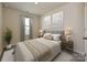 Cozy bedroom with a queen-sized bed, neutral walls, and soft lighting at 1636 Village Grove Ln, Monroe, NC 28110