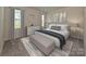 Comfortable bedroom with neutral color scheme, plush carpet, and bright windows at 1636 Village Grove Ln, Monroe, NC 28110