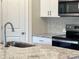 Close up of the sink with granite countertops, white cabinets, and stainless steel appliances at 1636 Village Grove Ln, Monroe, NC 28110