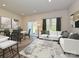 Comfortable living room with a white sofa, and view to dining area with sliding glass doors at 1636 Village Grove Ln, Monroe, NC 28110