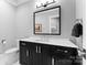 Stylish bathroom with dark vanity, white countertop, and a large mirror at 3645 Pelham Ln, Charlotte, NC 28211