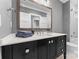 Modern bathroom with dark vanity, a large mirror, and a walk-in shower at 3645 Pelham Ln, Charlotte, NC 28211