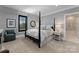 Elegant bedroom featuring a black post bed and ensuite bathroom at 3645 Pelham Ln, Charlotte, NC 28211