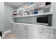 Bright laundry room with white cabinets and teal walls at 3645 Pelham Ln, Charlotte, NC 28211