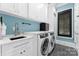 Modern laundry room with white cabinets and stylish backsplash at 3645 Pelham Ln, Charlotte, NC 28211