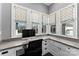 Home office with built-in desk, white cabinetry, and large windows at 3645 Pelham Ln, Charlotte, NC 28211