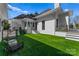 Artificial turf side yard with modern seating area and steps leading to home at 3645 Pelham Ln, Charlotte, NC 28211