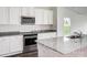 Well-lit kitchen featuring stainless steel appliances, granite countertops, and white cabinets at 180 Wembury Ln, Troutman, NC 28166