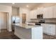 Open kitchen with stainless steel appliances, granite countertops, a center island, and white cabinets at 180 Wembury Ln, Troutman, NC 28166