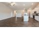 Bright open concept living area featuring wood floors, lots of natural light and a view of the kitchen at 180 Wembury Ln, Troutman, NC 28166