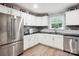 Bright kitchen featuring stainless steel refrigerator, white cabinets, and updated countertops at 317 Annafrel St, Rock Hill, SC 29730