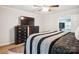 Bright main bedroom featuring ceiling fan and dark wood furnishings, plus a large flatscreen television at 317 Annafrel St, Rock Hill, SC 29730