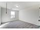 Simple bedroom with grey carpet and a window at 12320 Riceland Way, Midland, NC 28107