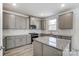 Modern kitchen with gray cabinets, granite countertops and island at 12320 Riceland Way, Midland, NC 28107