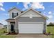 Two-story house with gray siding, a two-car garage, and landscaping at 731 Olde England Dr, Lincolnton, NC 28092