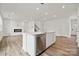 Modern kitchen with white cabinets, island, and stainless steel dishwasher at 731 Olde England Dr, Lincolnton, NC 28092
