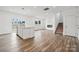 Open living area with hardwood floors, fireplace, and kitchen island at 731 Olde England Dr, Lincolnton, NC 28092