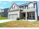 Two-story house with gray siding, solar panels, and a two-car garage at 1109 Creedmore Ct, Charlotte, NC 28215