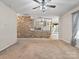 Living room with stone fireplace and kitchen views at 1561 Wilburn Park Ln, Charlotte, NC 28269