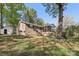 Home's backyard featuring a screened porch, dark shutters and a well-manicured lawn at 1725 Feature Rd, Lancaster, SC 29720